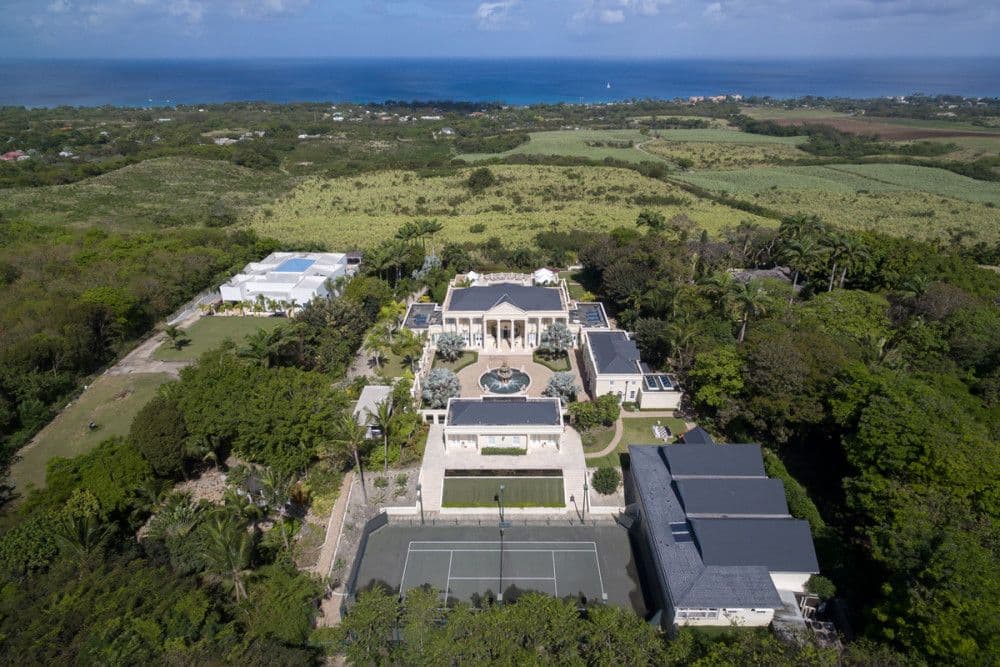 Aerial view of the full 2.68-acre Ridge estate with pool, tennis court and sea beyond