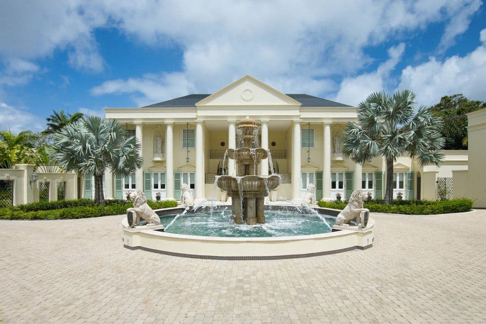 Grand columned entrance and lion courtyard fountain at The Ridge