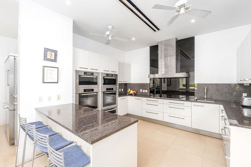 Main kitchen with a granite island, bar seating and professional appliances at The Ridge