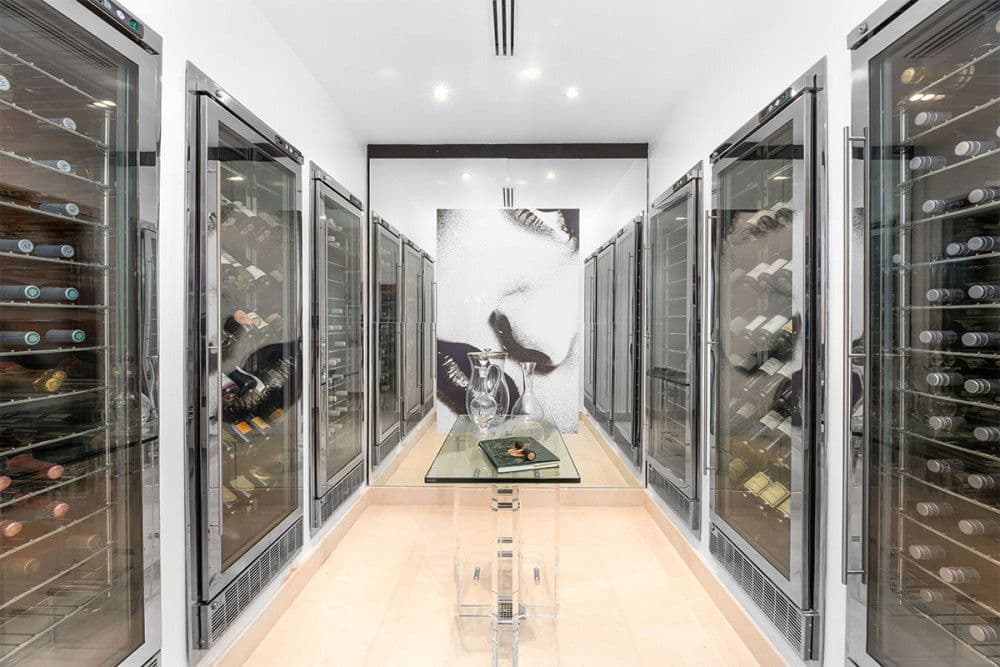 Glass-fronted wine room lined with temperature-controlled cabinets at The Ridge