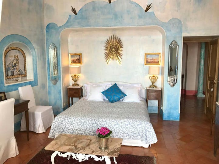 Summer in Praiano master bedroom with blue frescoes and arched alcove, Praiano, Amalfi Coast, Italy