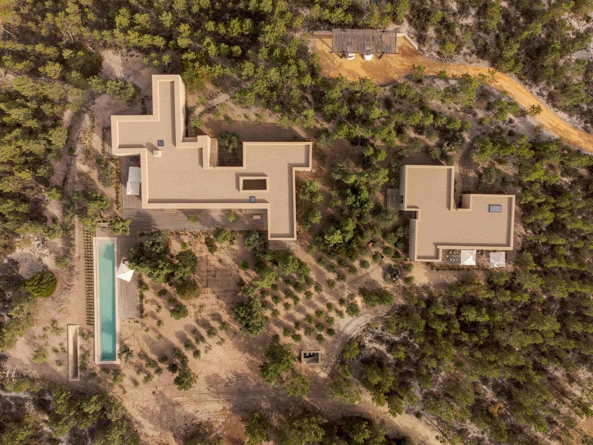 Overhead view of the two-building villa and pool among the pines at Mighty Pine