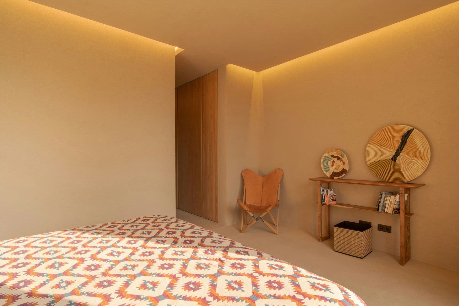 Guest bedroom with a kilim throw and butterfly chair at Mighty Pine