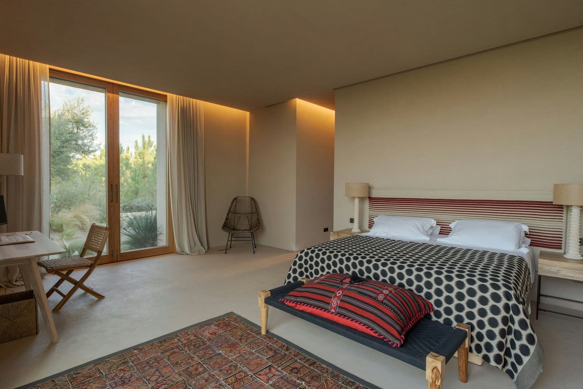 Bedroom opening to the garden with terracotta textiles at Mighty Pine