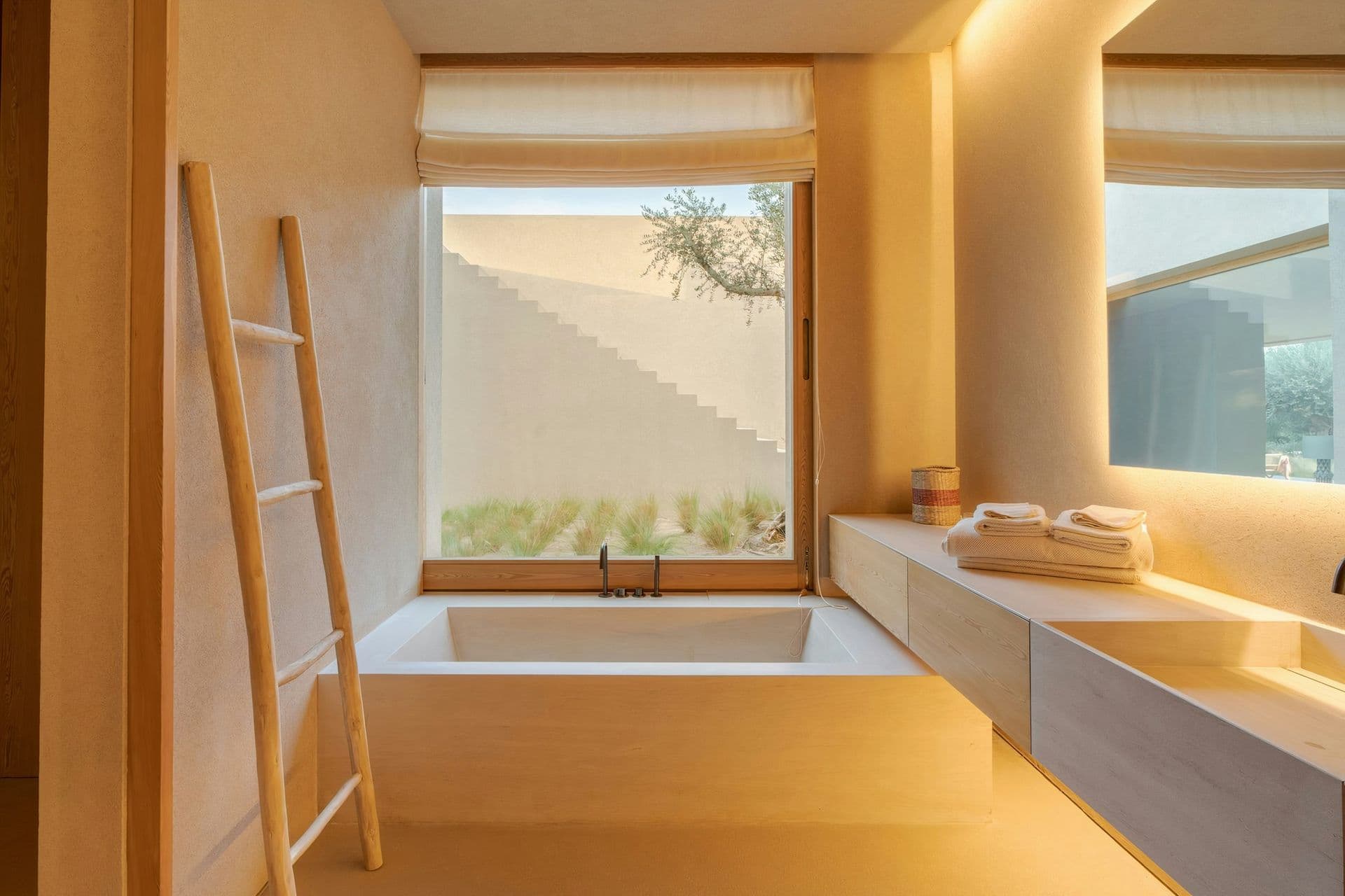 Sunken bath set below a window onto the garden at Mighty Pine