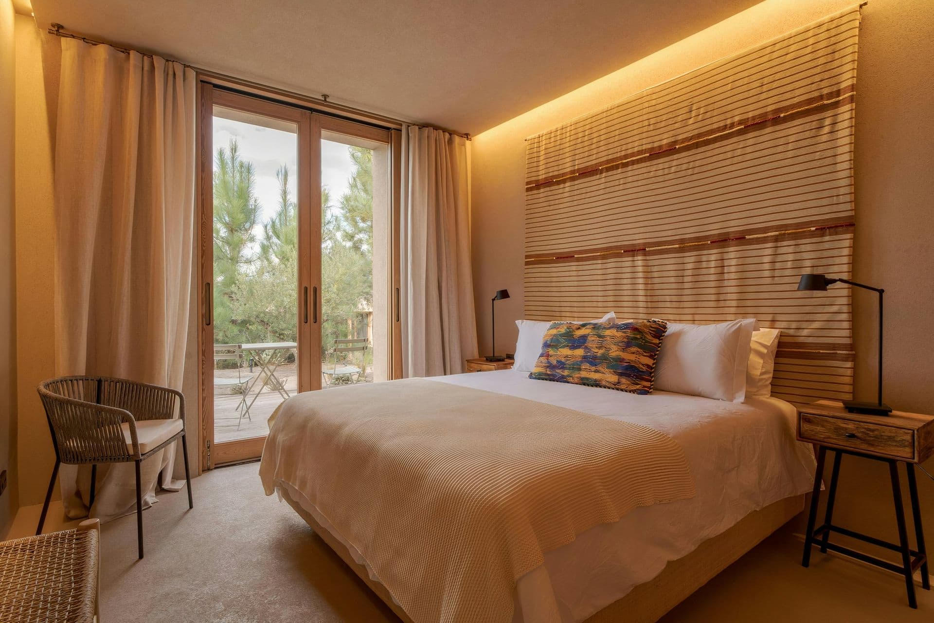 Bedroom with a bamboo headboard and warm lighting at Mighty Pine