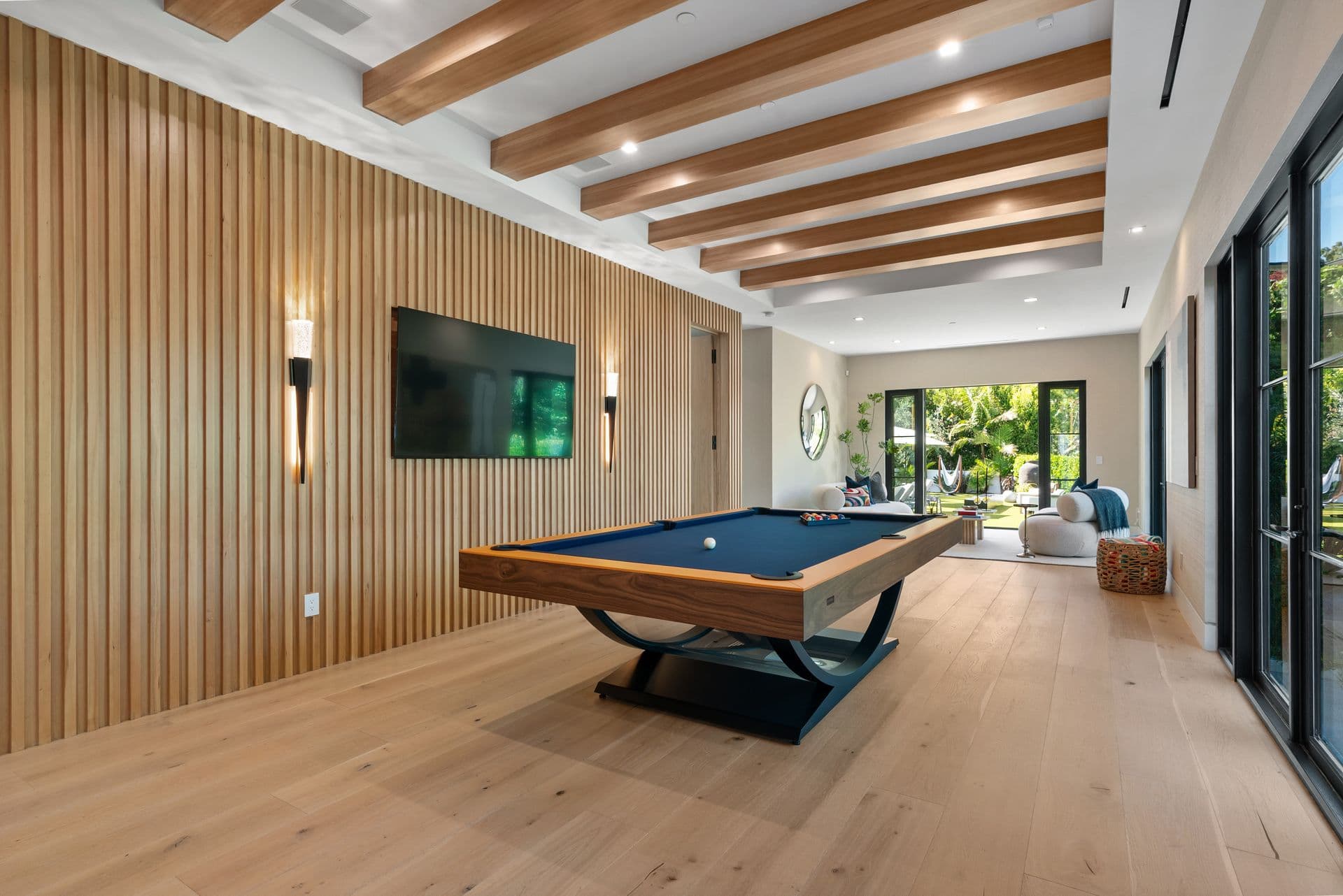 Games room with a pool table and timber-slat walls at Bel-Air Oasis, Los Angeles