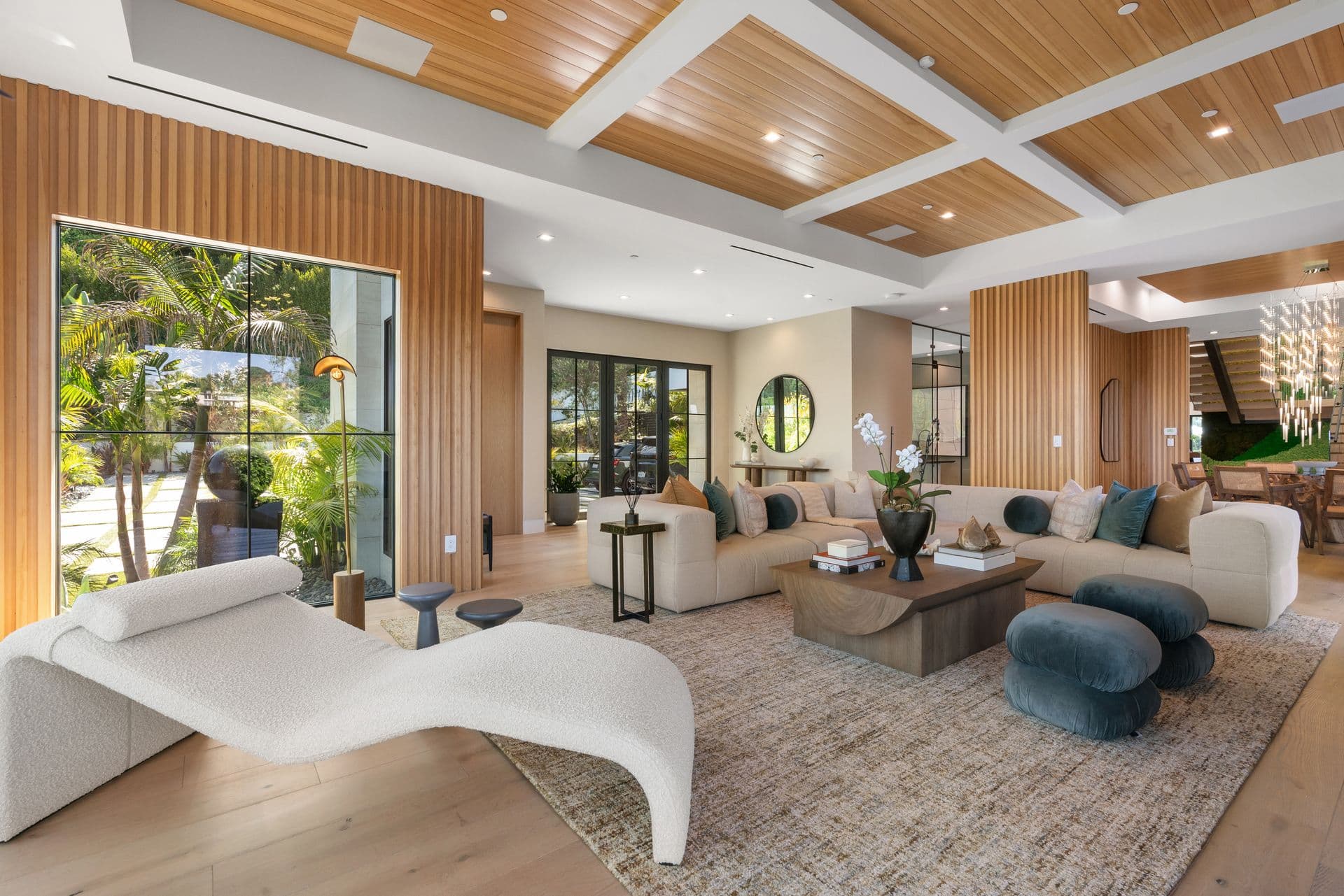 Great room with a coffered timber ceiling and sculptural chaise at Bel-Air Oasis, Los Angeles