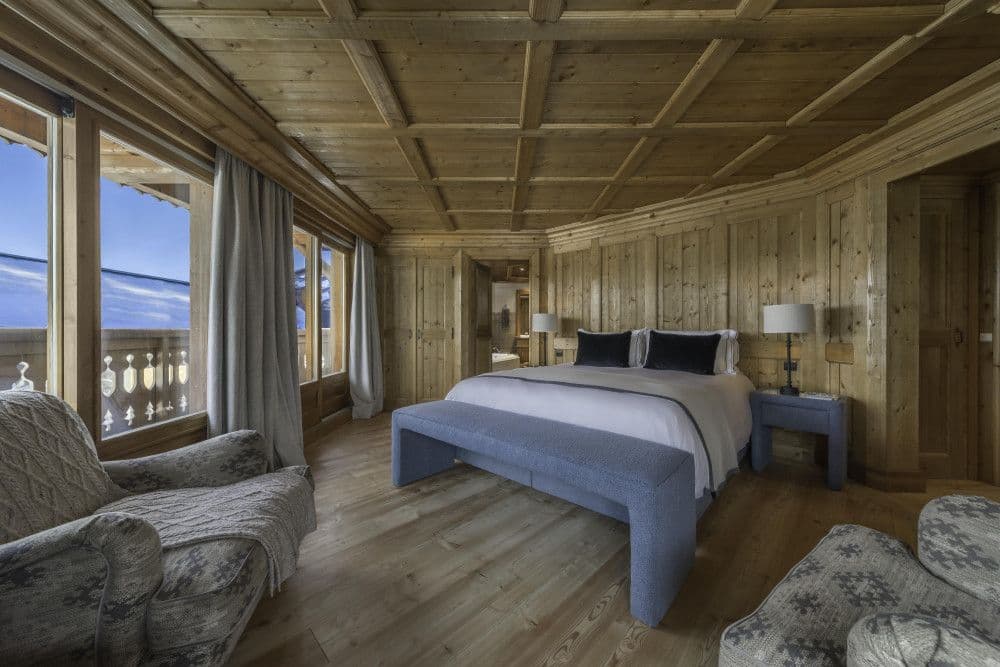 Master bedroom opening to a balcony with mountain views at Courchevel 13