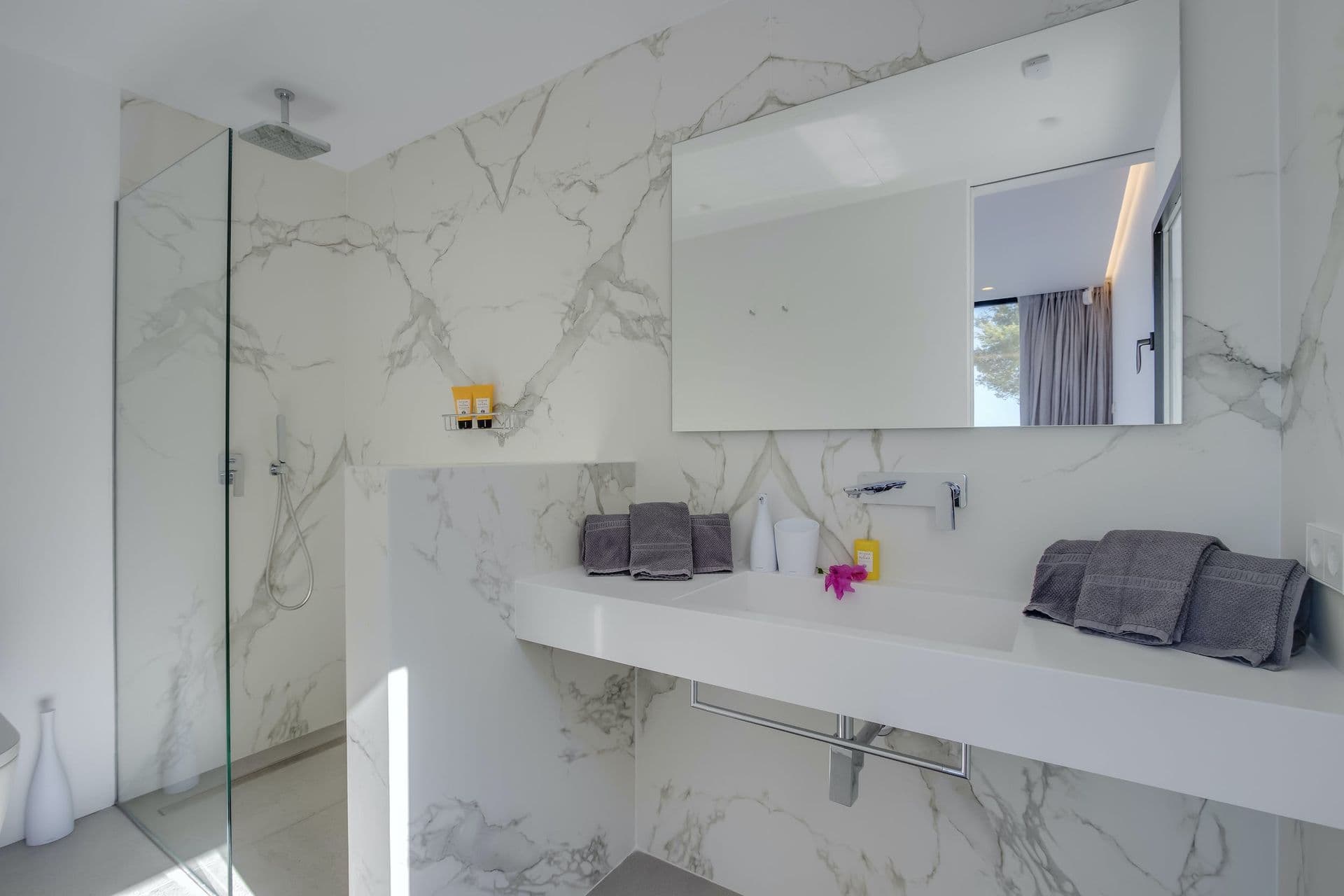 Marble bathroom with a double vanity and walk-in shower at Dancing Shadows, Ibiza