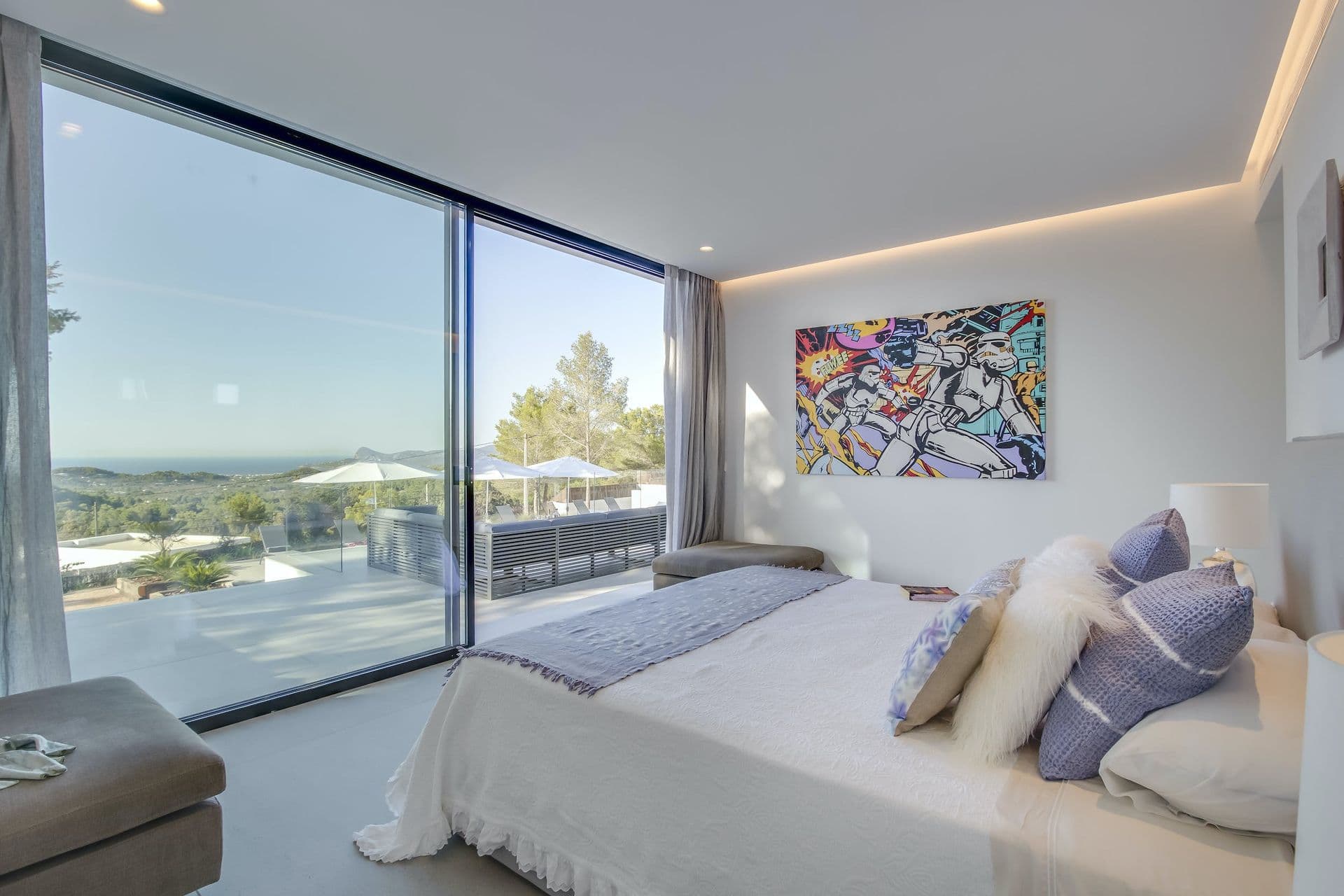 Double bedroom with a floor-to-ceiling window onto the hills at Dancing Shadows, Ibiza