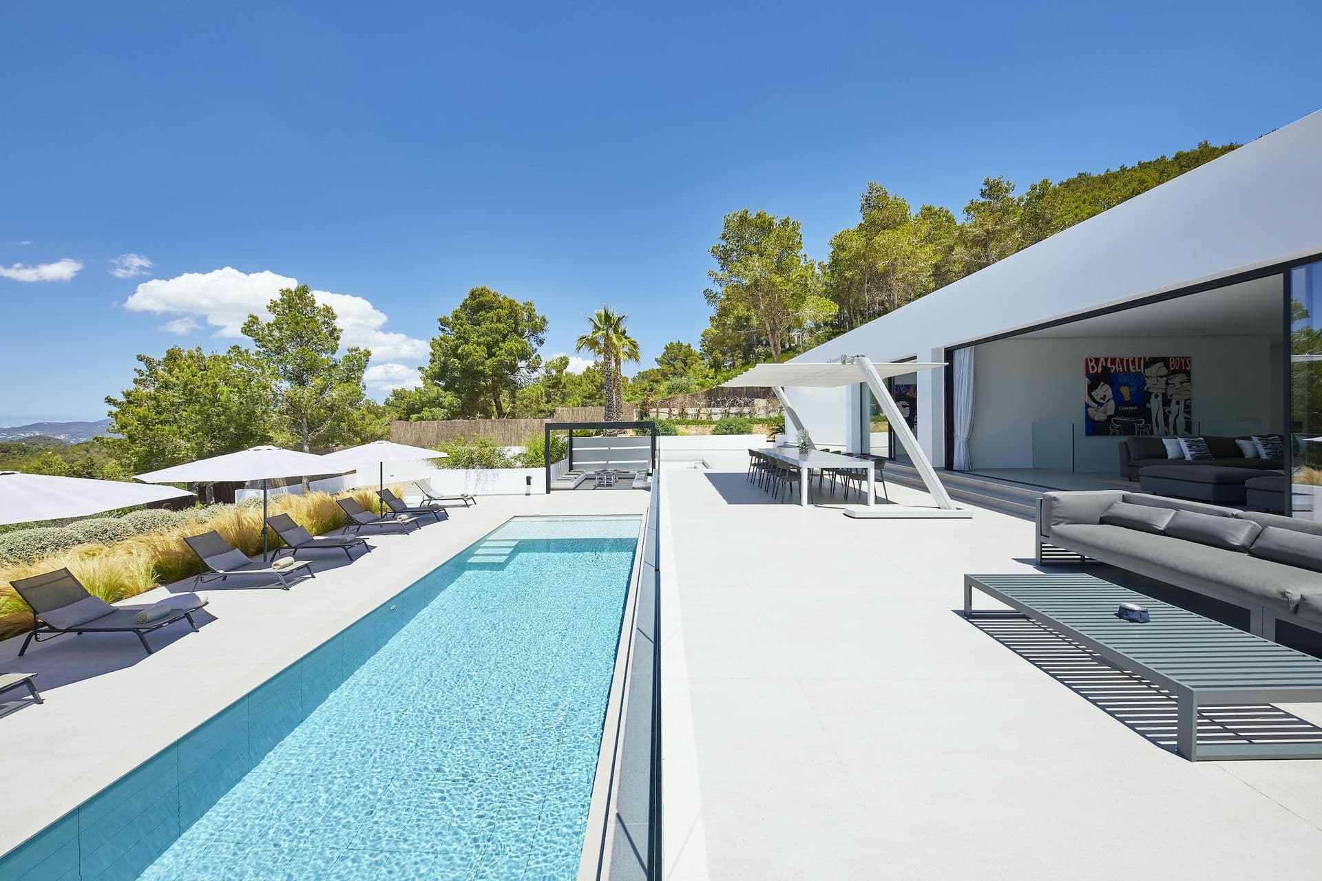 Infinity pool and terrace beside the angular white villa at Dancing Shadows, Ibiza