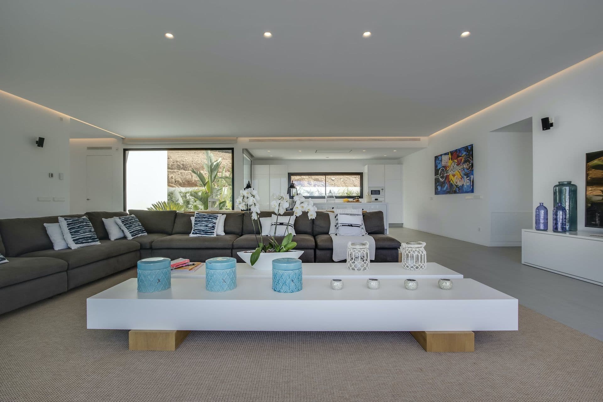 Open-plan lounge with grey sofas around a low coffee table at Dancing Shadows, Ibiza