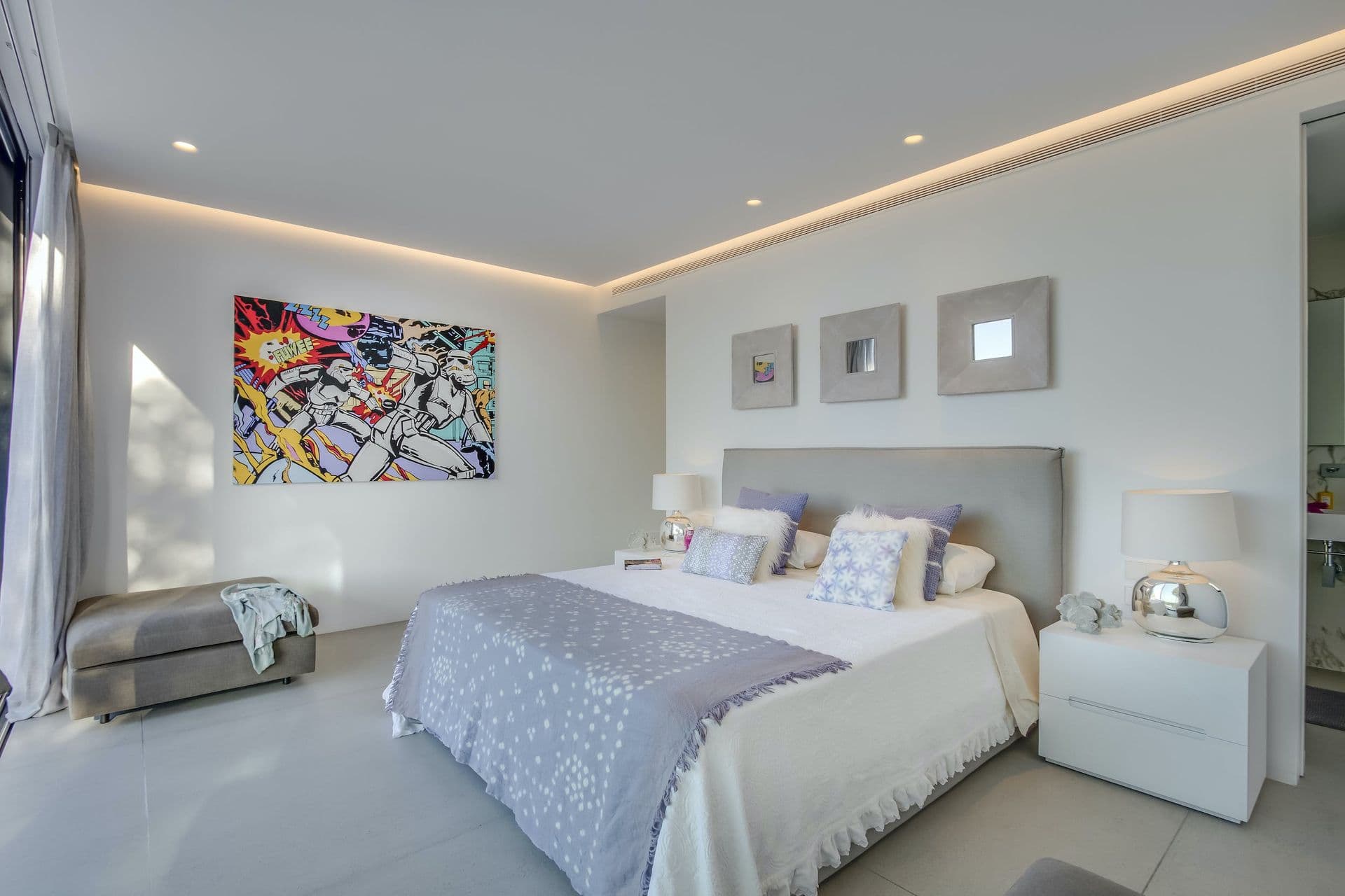 Master bedroom in white and grey with bold pop-art above the bed at Dancing Shadows, Ibiza