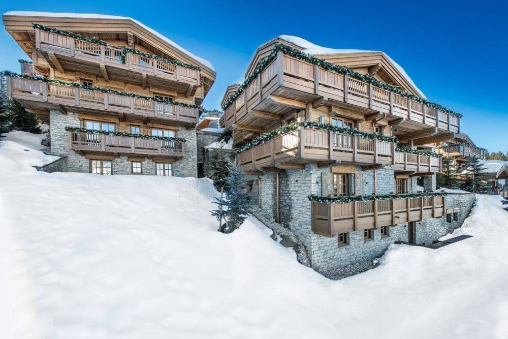 Timber and stone chalet under snow in Courchevel 1850