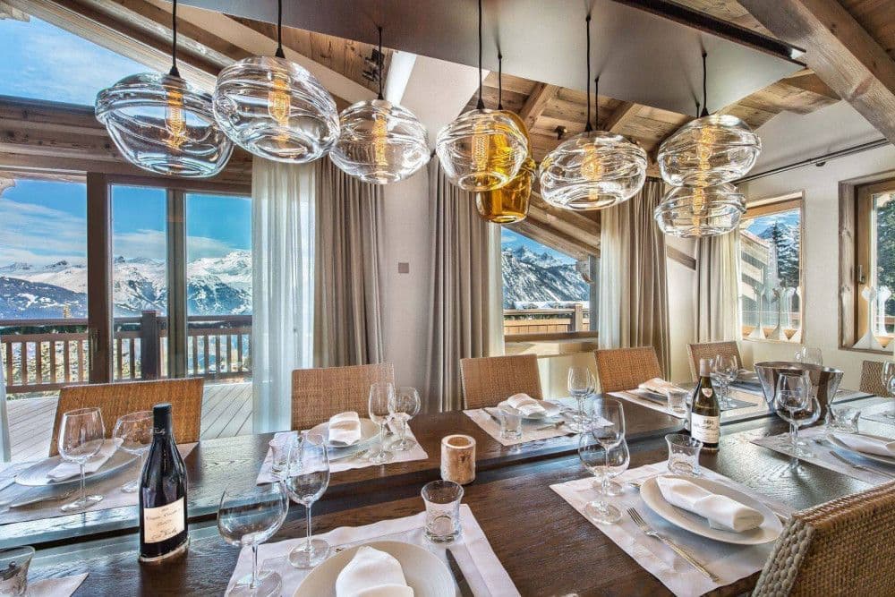 Dining room with glass pendants and mountain views at Courchevel 17