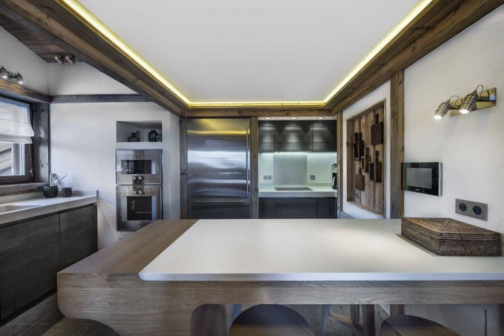 Timber kitchen with a breakfast table at Courchevel 17
