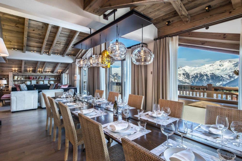 Open-plan living and dining room with panoramic mountain windows at Courchevel 17