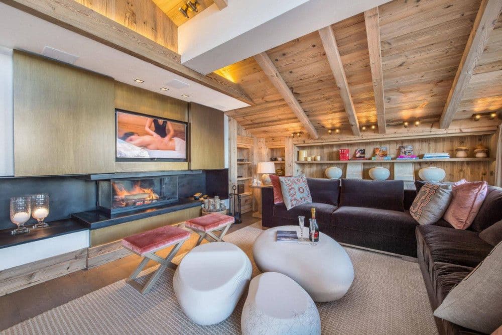 Living room with a fireplace and sculptural seating at Courchevel 17