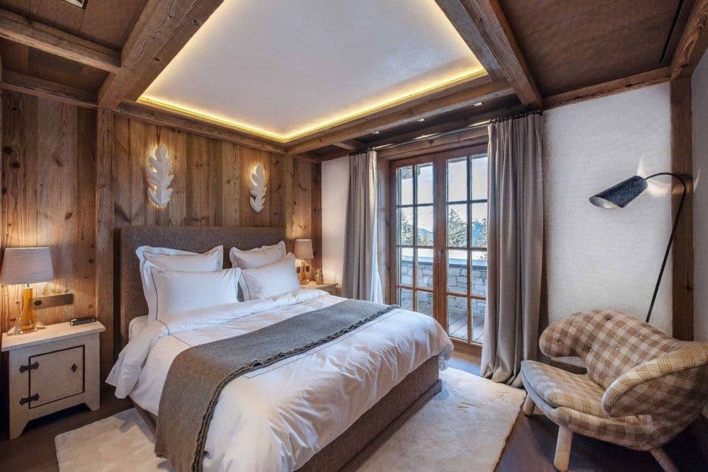 Master bedroom panelled in warm timber at Courchevel 17