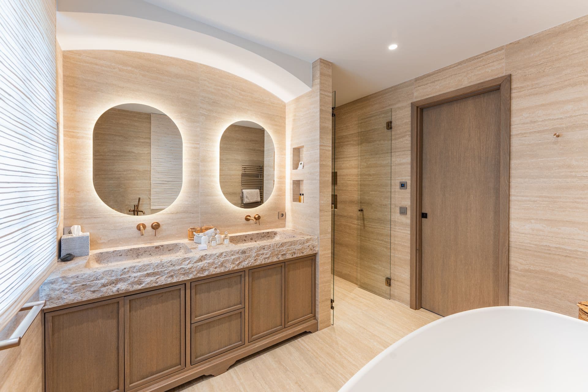 Ensuite bathroom with arched mirrors over a double vanity.