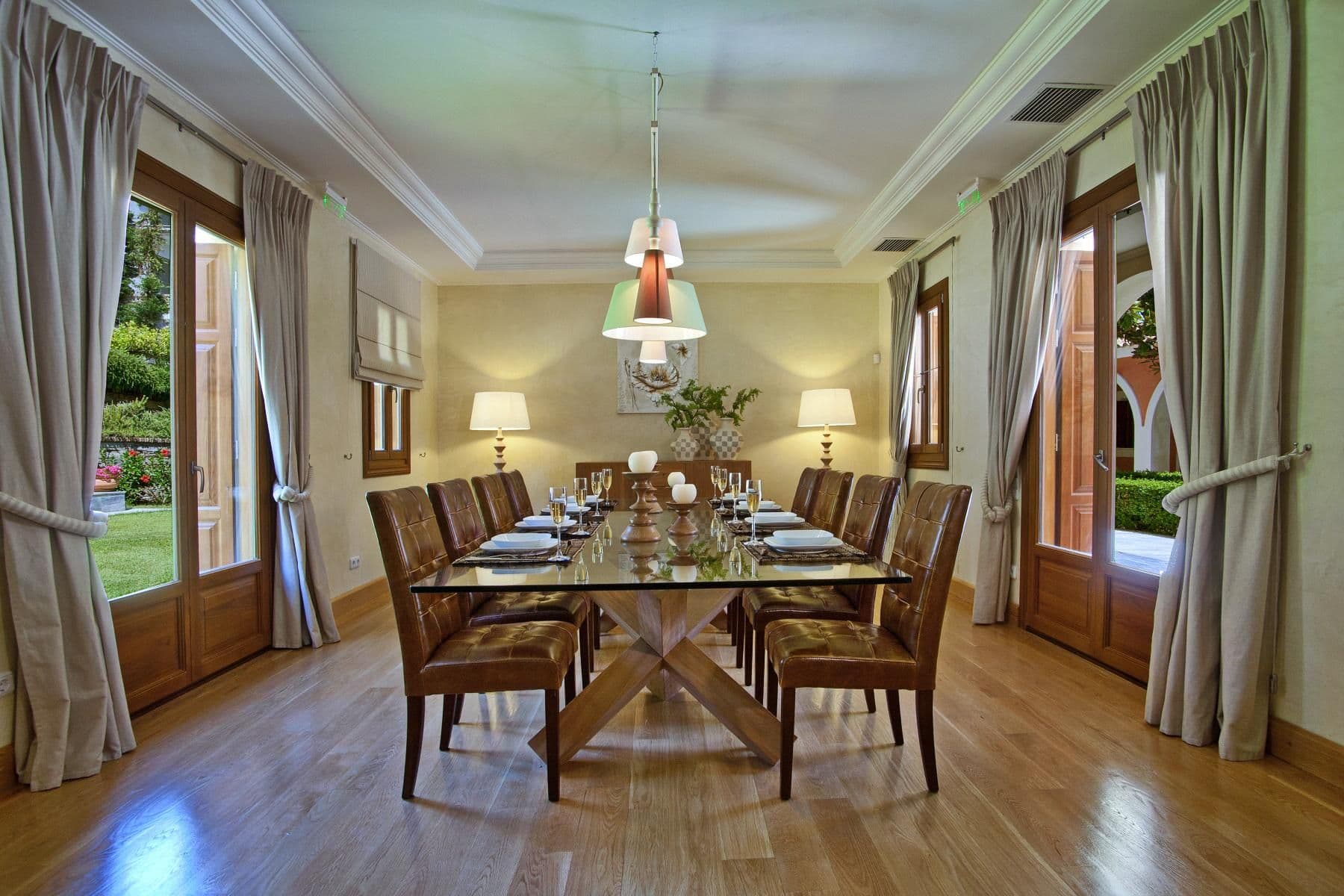 Formal dining room with a long wooden table set for eight