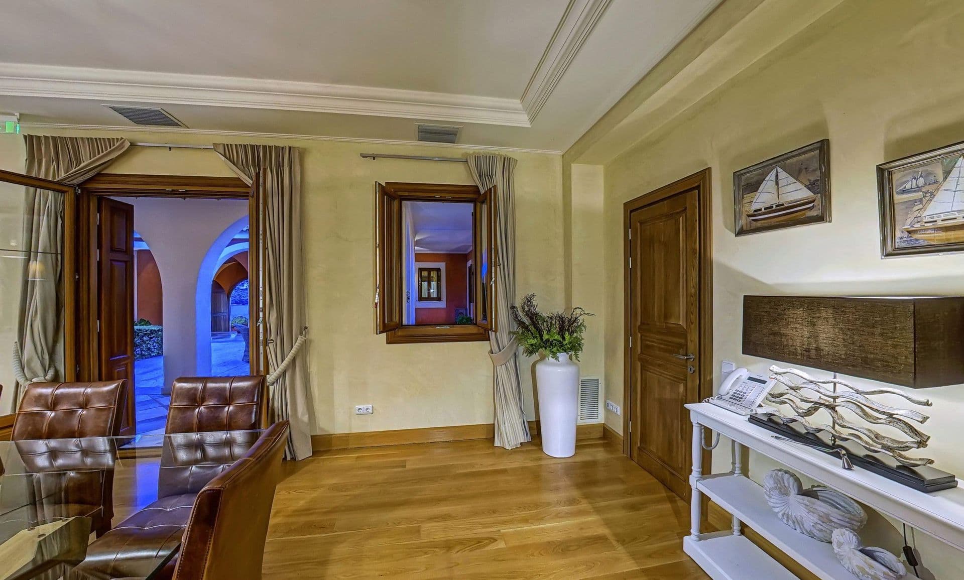 Villa hallway with wooden doors opening onto the garden