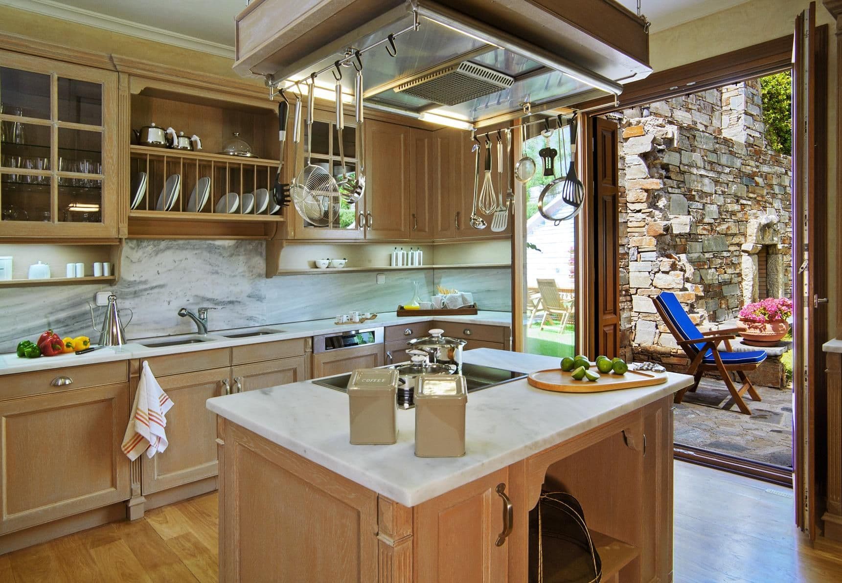 Farmhouse-style kitchen with a central island and exposed stone wall