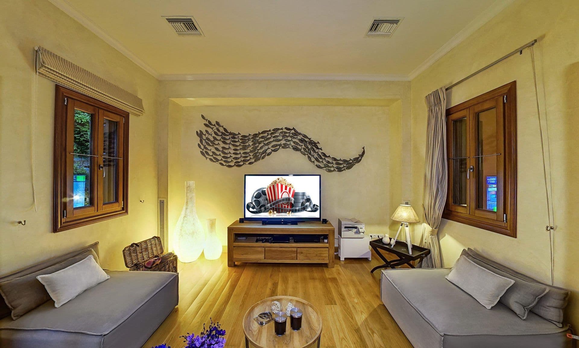 Bright living room with two sofas, television and garden doors
