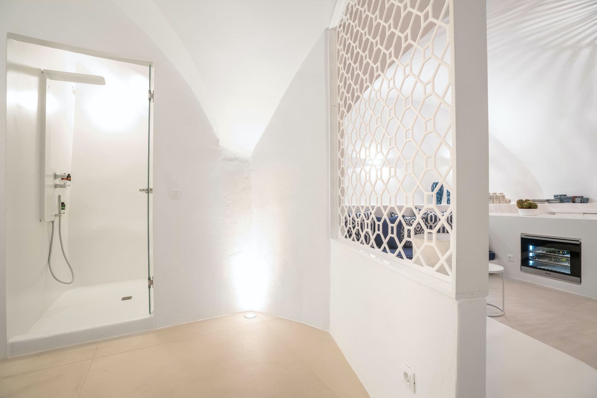Cave style domed shower room finished in white plaster.