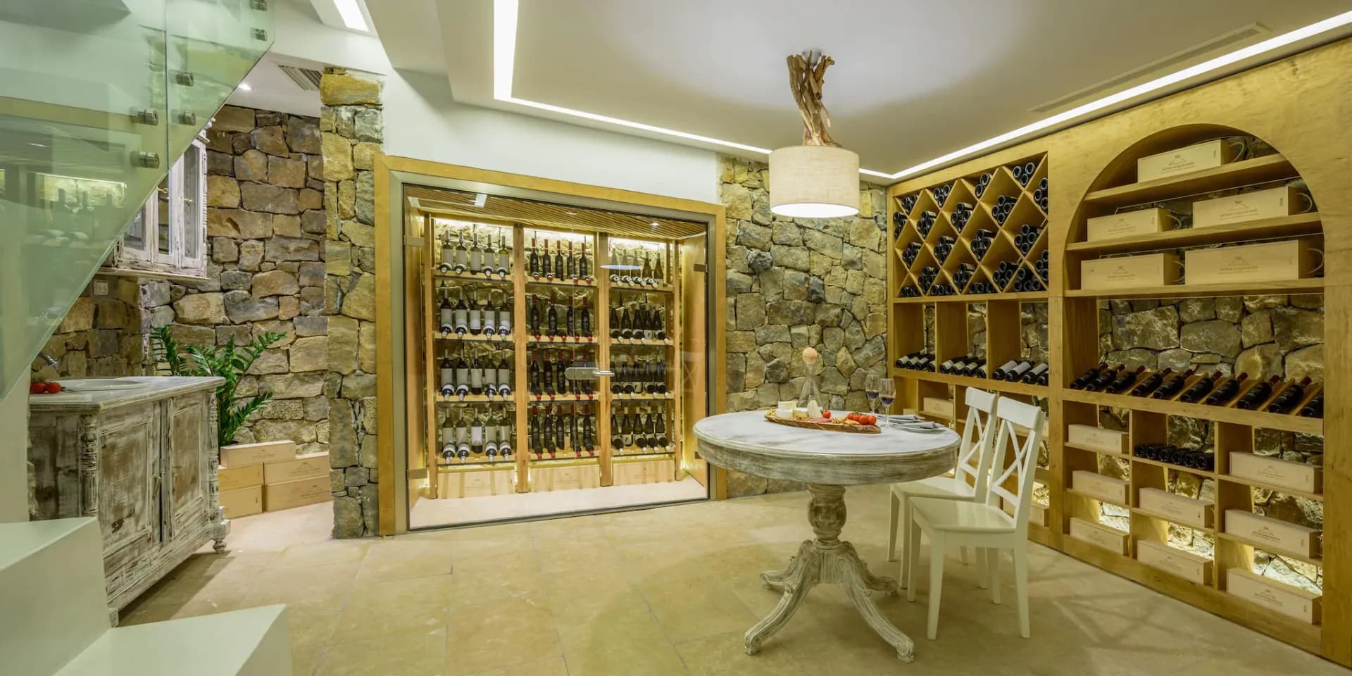 The private wine cellar at Gaia's Rest, carved into stone with a tasting table.