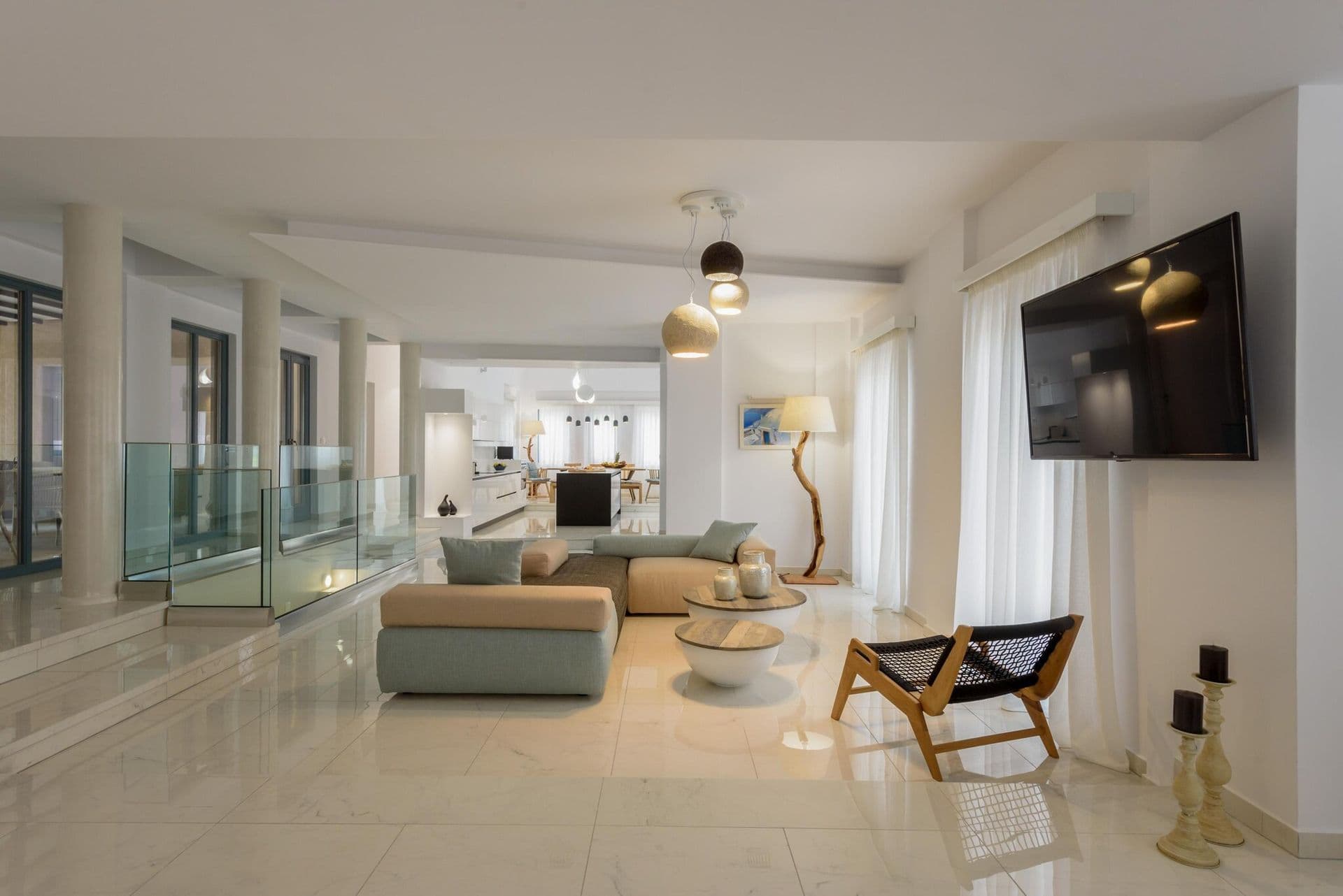 Open plan living area at Gaia's Rest with soft furnishings and sea view windows.