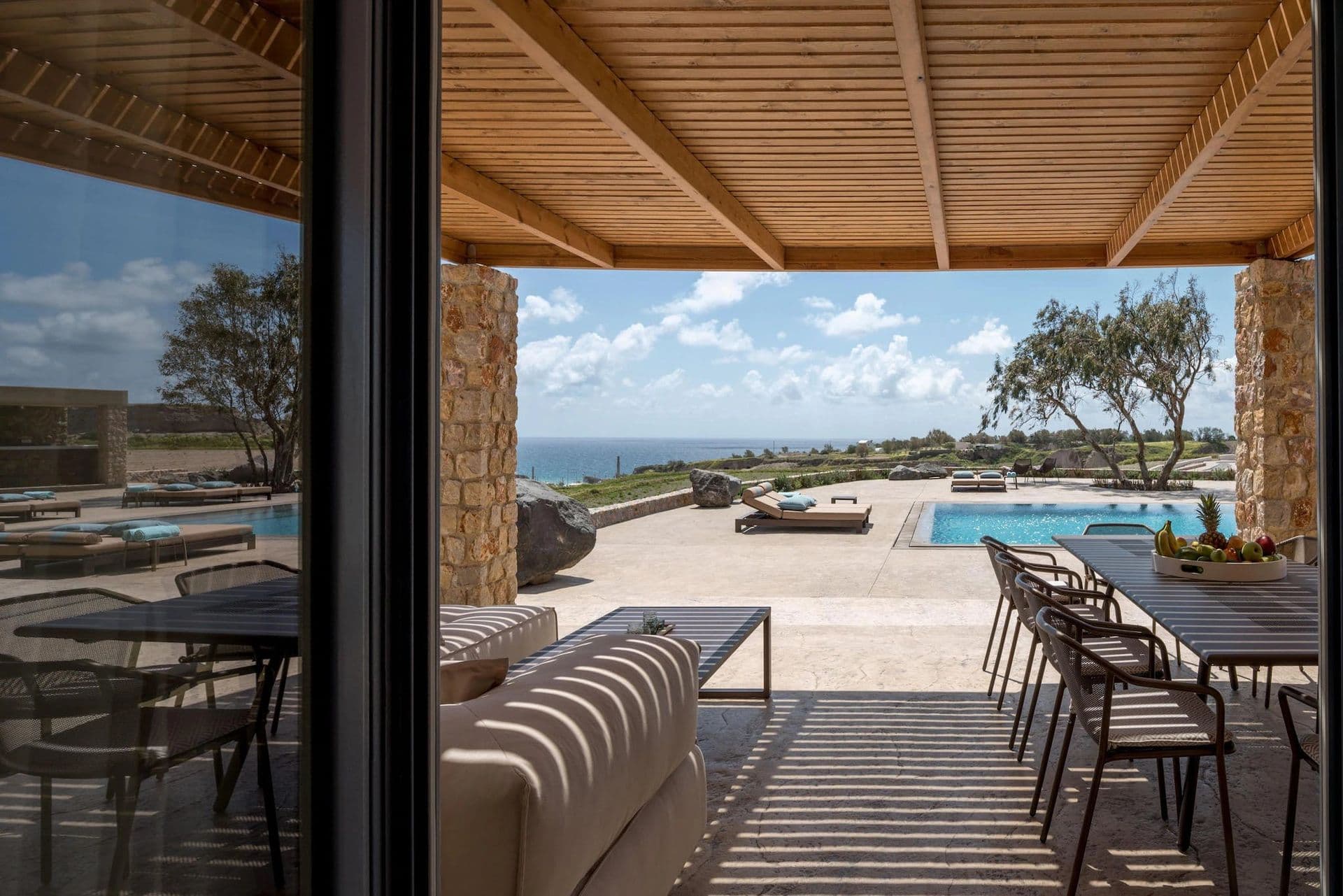 Covered terrace dining area at Gaia's Rest overlooking the pool and sea.