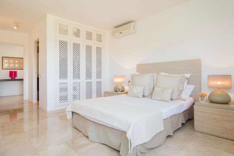 Bright master bedroom with a fitted wardrobe and skylight at Moon Kite