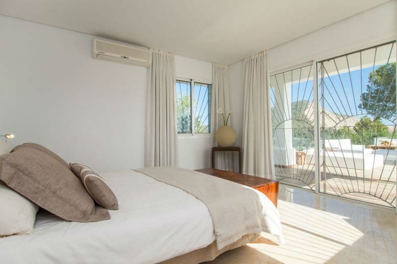 Bedroom with sliding glass doors opening directly onto the terrace at Moon Kite