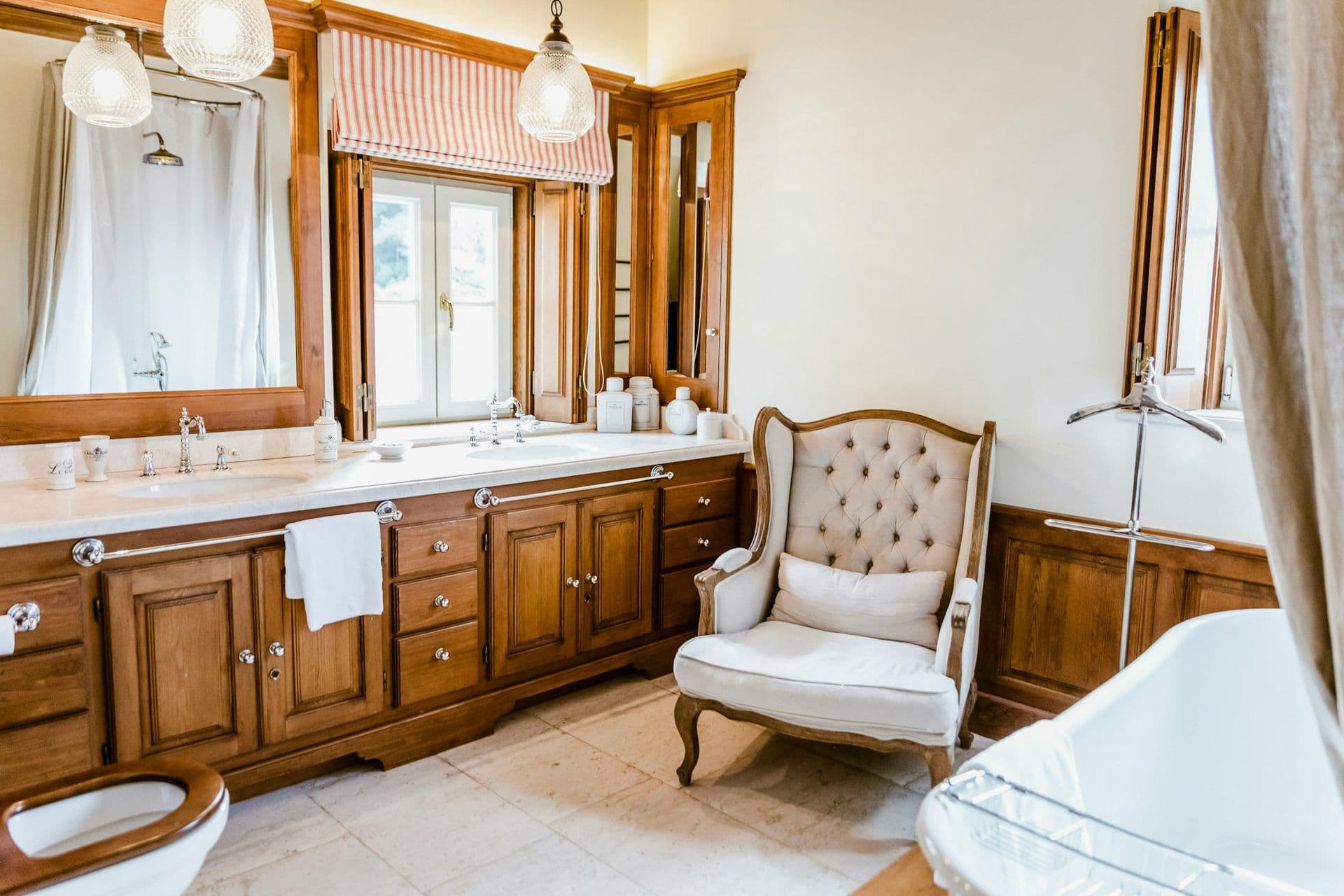En-suite bathroom with a timber double vanity and roll-top bath at Romantic Outlook