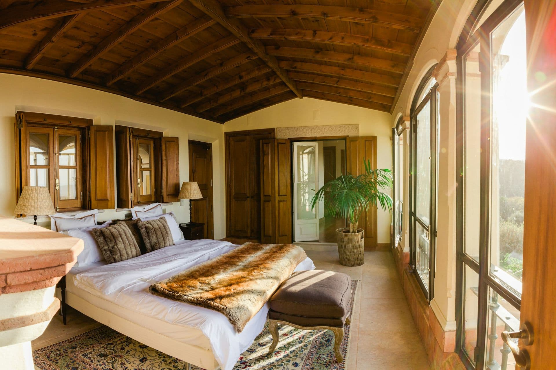 Bedroom with a fireplace and vaulted timber ceiling at Romantic Outlook, Sintra