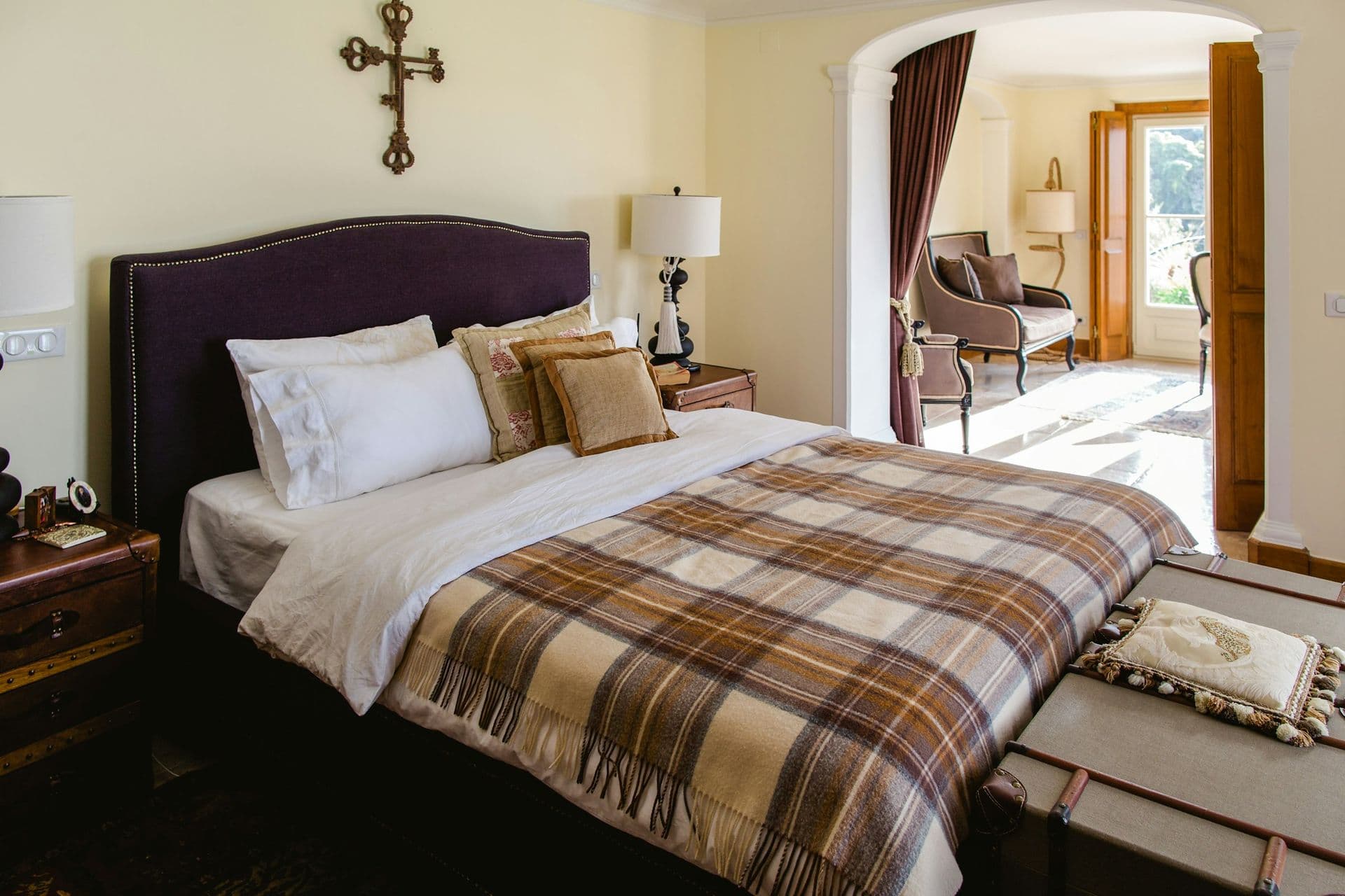 Double bedroom with an upholstered headboard opening to a sitting room at Romantic Outlook