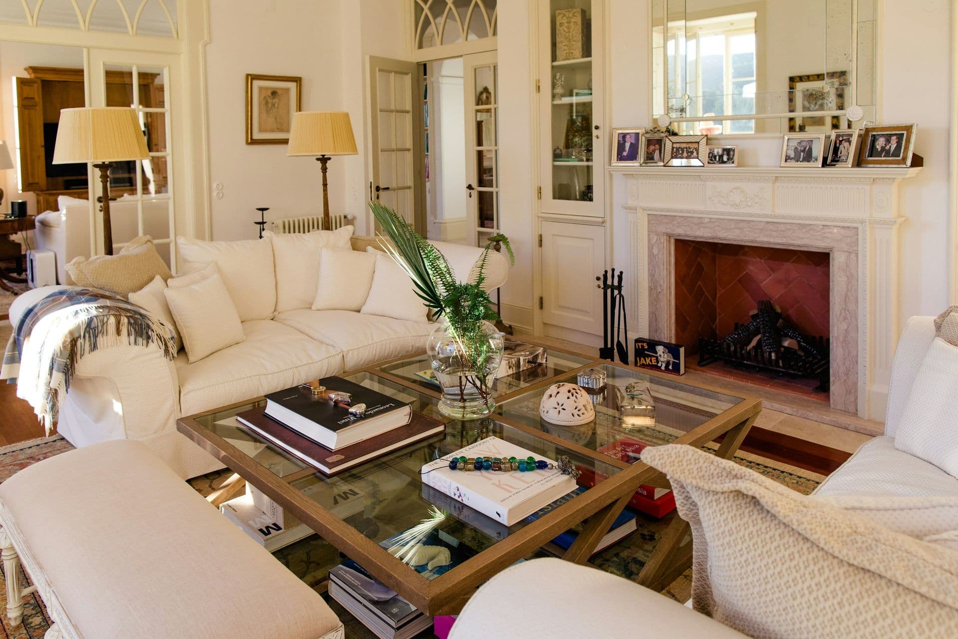 Grand living room with a marble fireplace and white sofas at Romantic Outlook