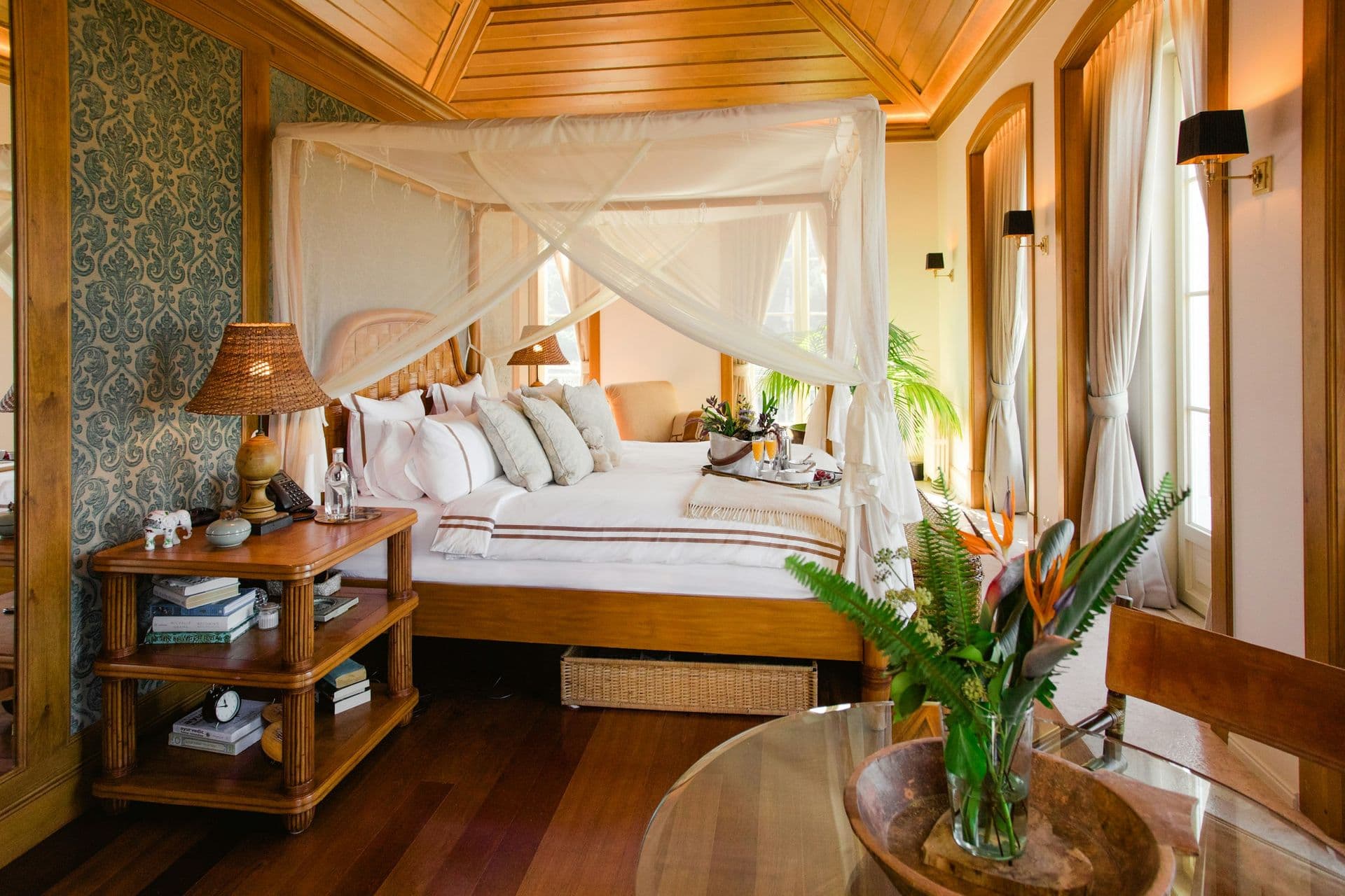 Four-poster master bedroom with a canopy and timber ceiling at Romantic Outlook