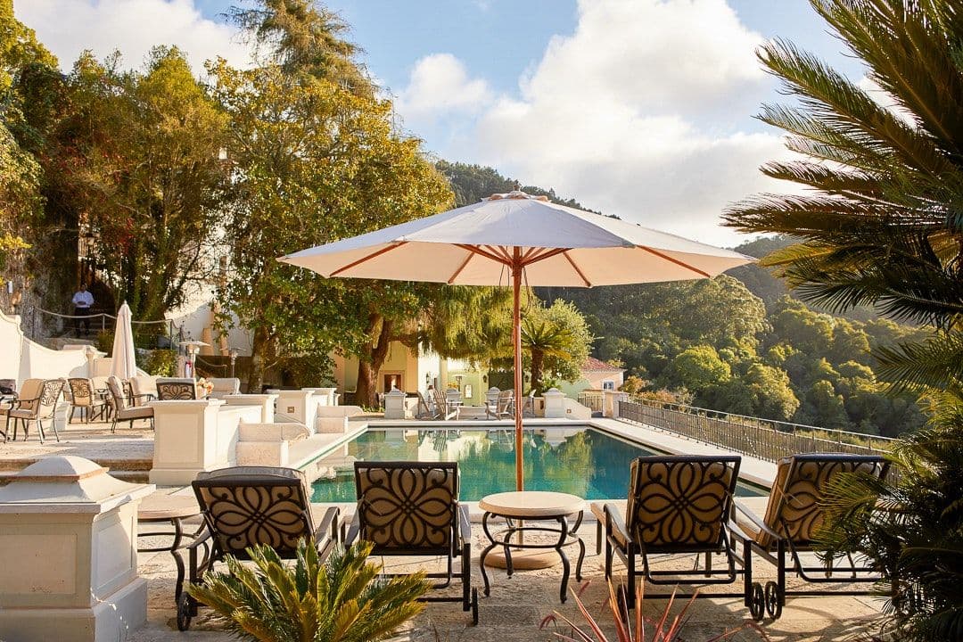 Swimming pool and sun terrace with parasols at Romantic Outlook, Sintra