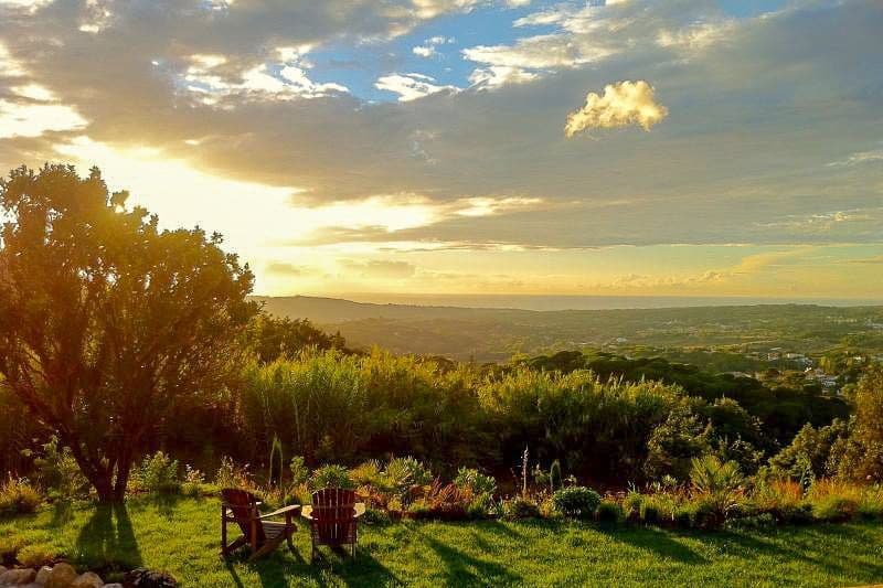 Sunset view over the wooded hills and coastal plain from the Romantic Outlook estate