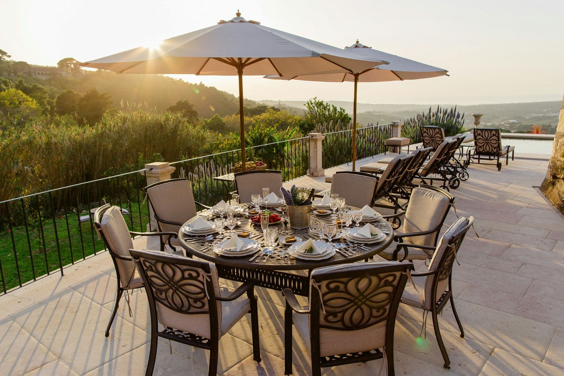 Outdoor dining table set on the terrace at sunset at Romantic Outlook