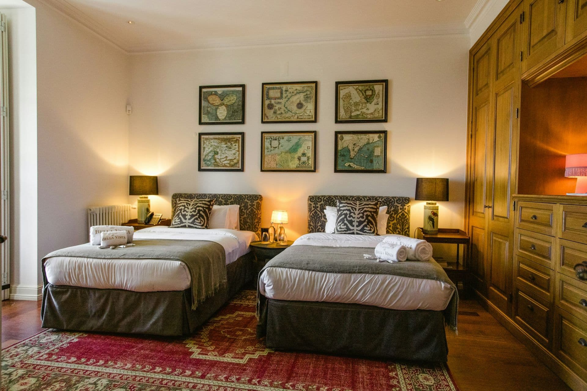 Twin bedroom with framed antique maps at Romantic Outlook, Sintra