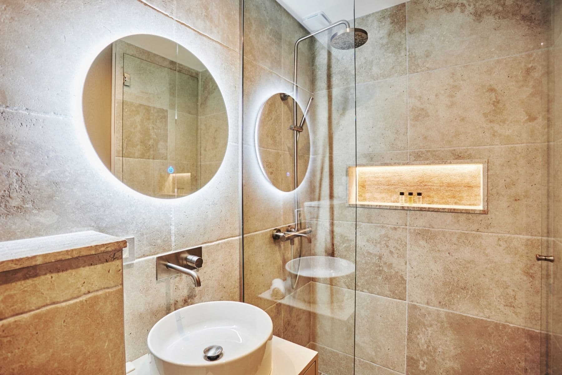 Ensuite bathroom with double round backlit mirrors and walk-in shower