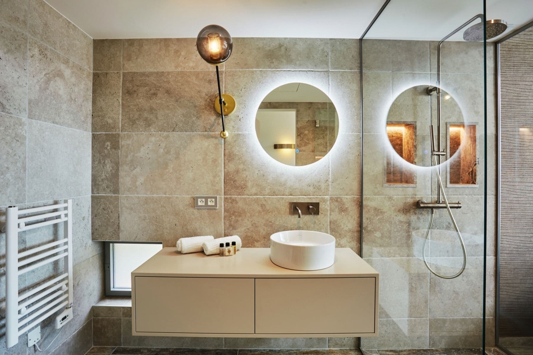 Bathroom with heated towel rail, vanity and glass-enclosed shower