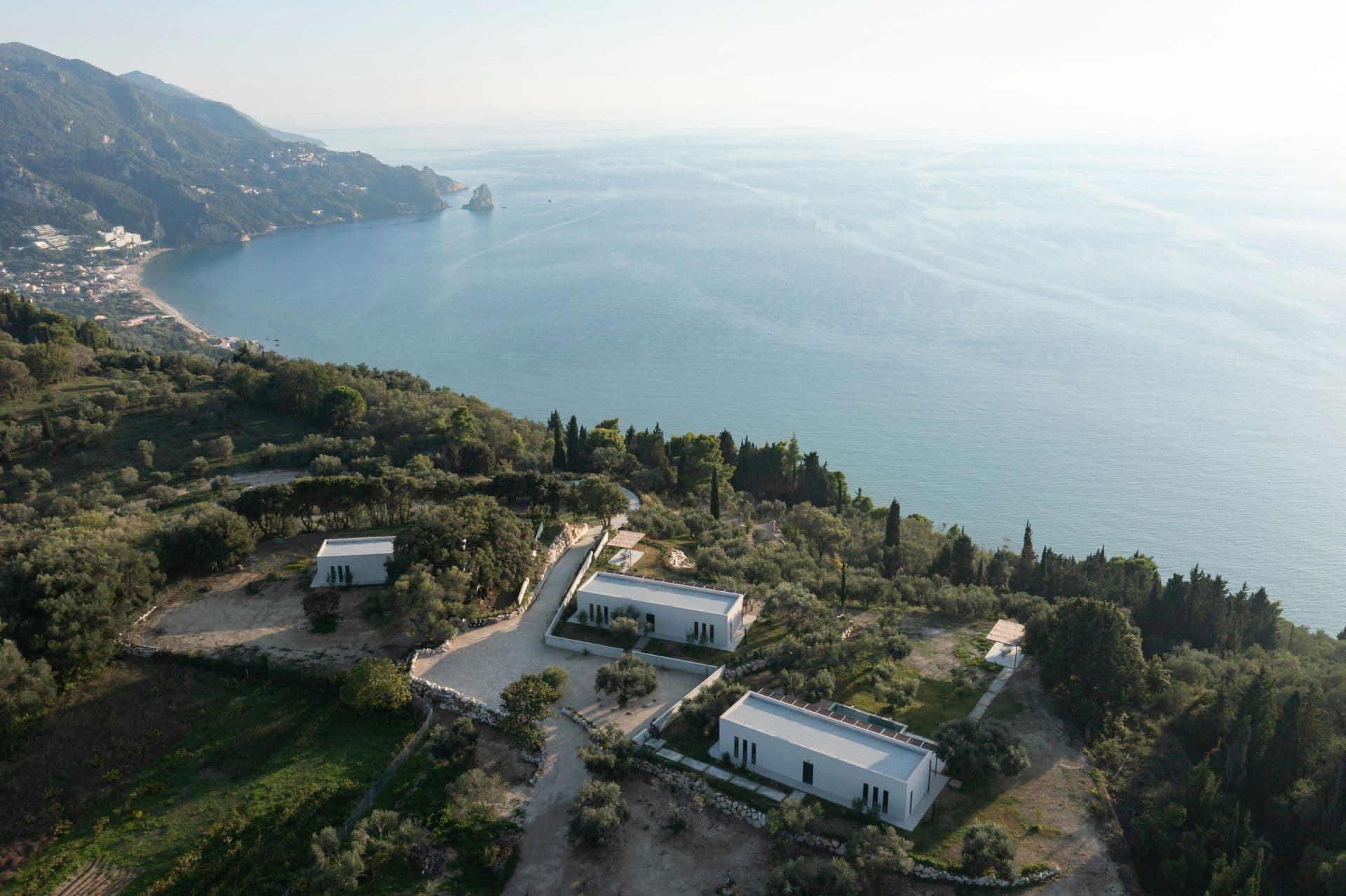 Aerial view of the villa and grounds above the Corfu coastline at Corfu Dreams, Corfu