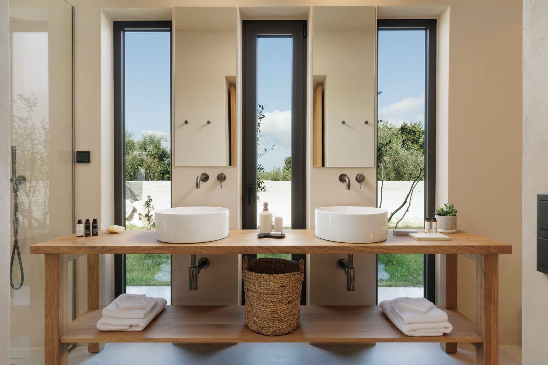 En-suite with twin vessel basins on an oak vanity below sea-view windows at Corfu Dreams, Corfu