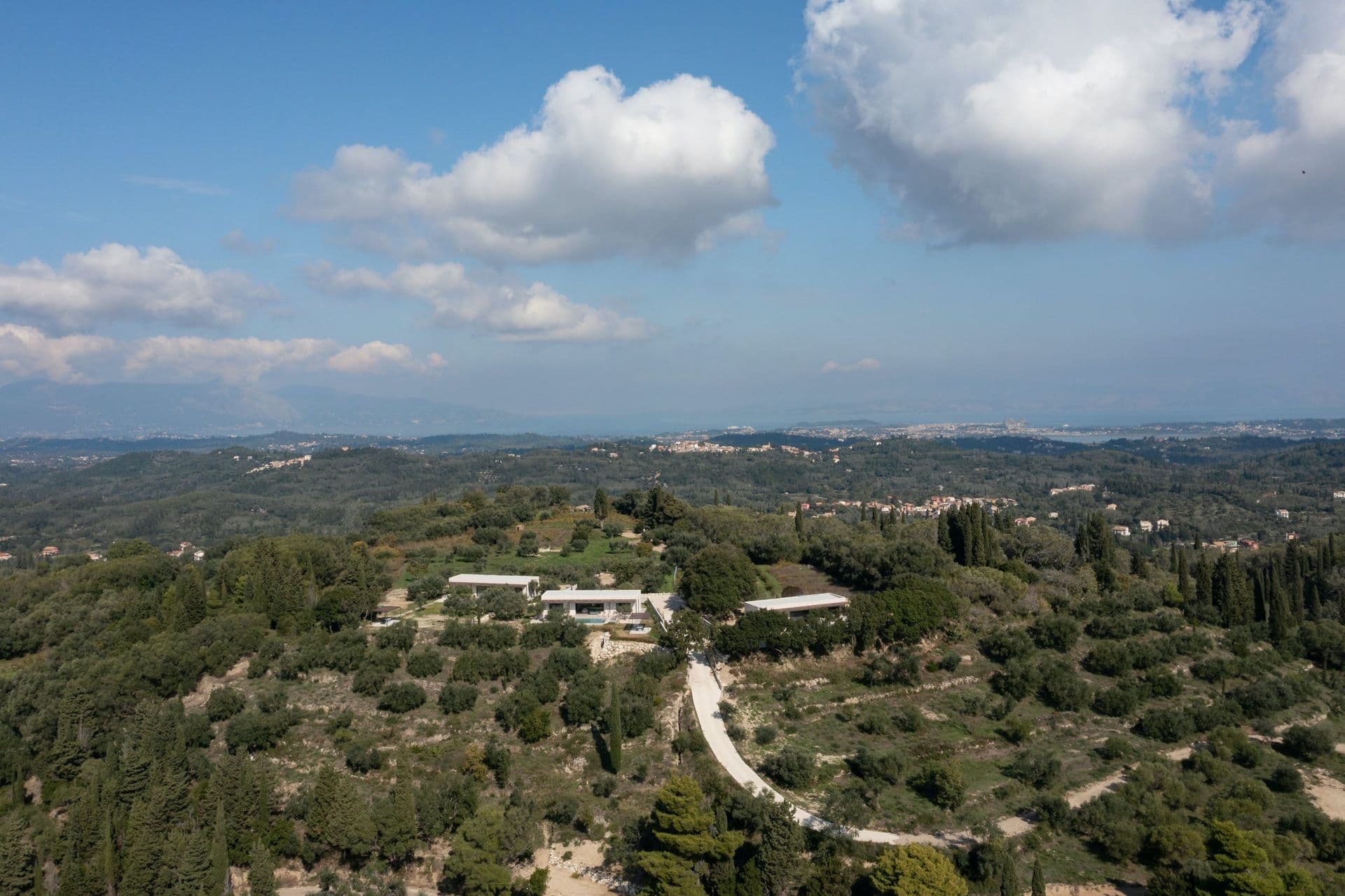 Aerial view of the villa among olive groves and cypresses on Corfu at Corfu Dreams, Corfu