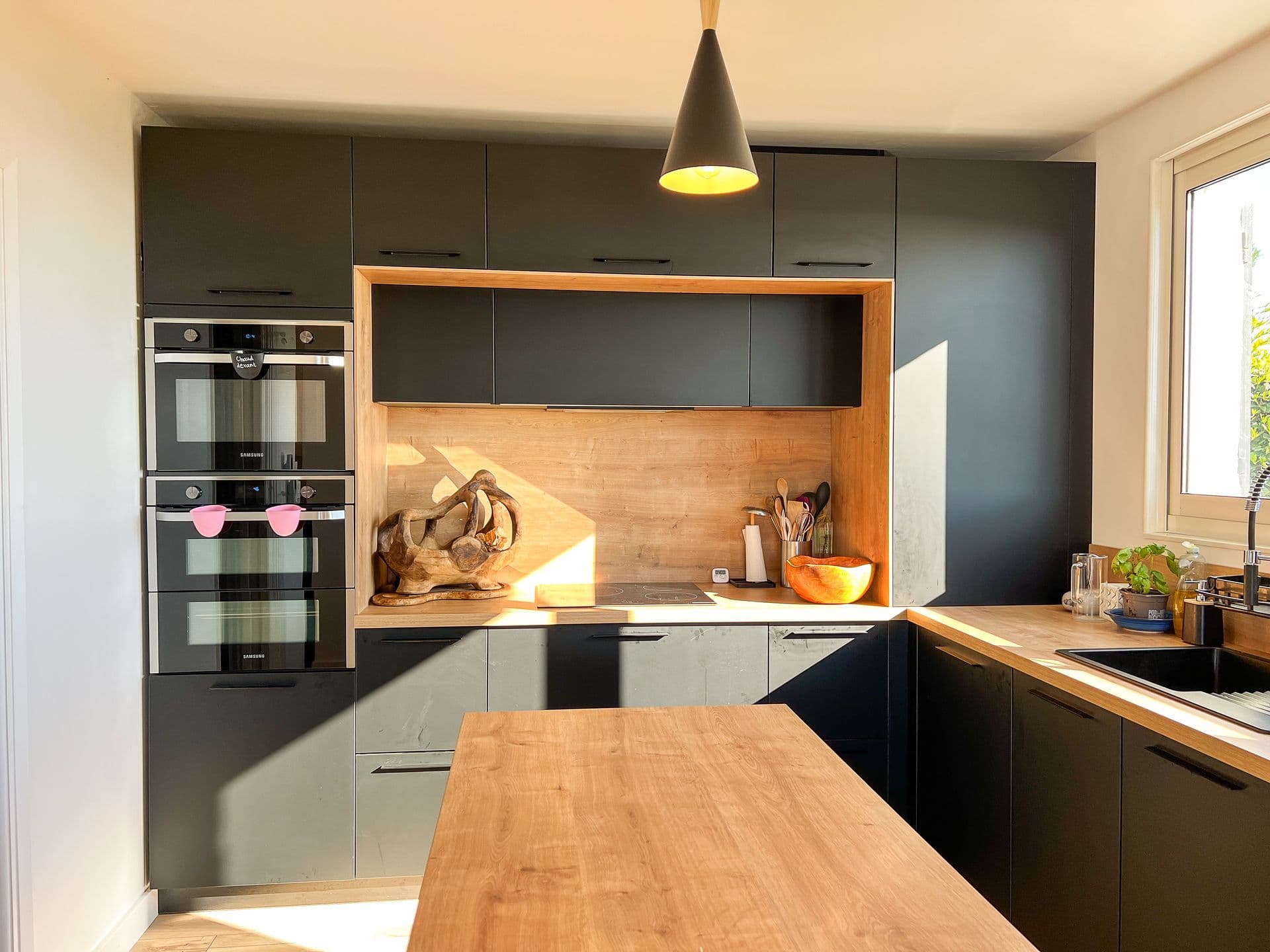 Kitchen with double ovens and matte black cabinetry at Southern Beauty